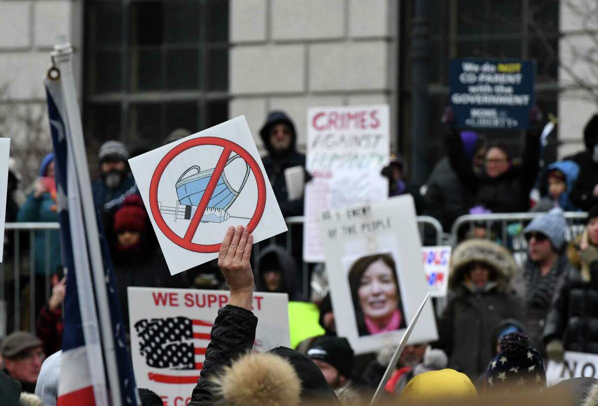 Demonstrators, upset with state coronavirus mandates and restrictions, protest in West Capitol Park ahead of Gov. Kathy Hochul’s first State of the State address on Wednesday, Jan. 5, 2022, in Albany, N.Y.