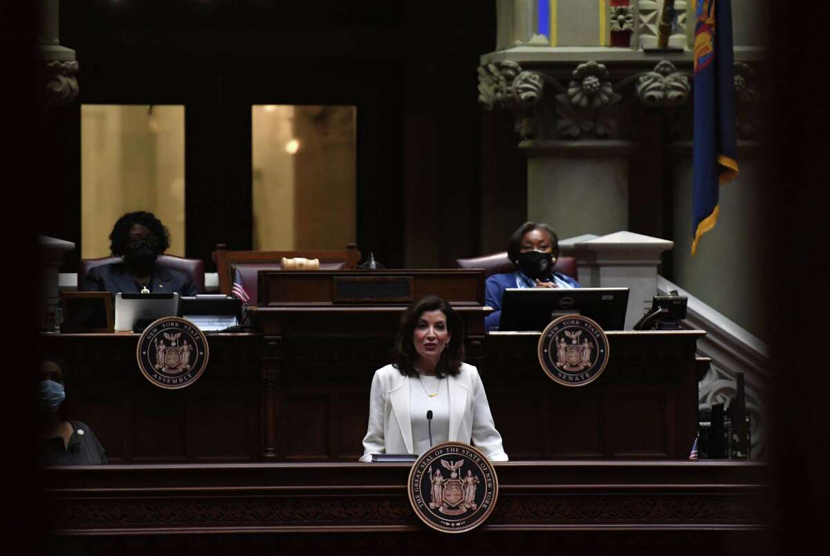 Gov. Kathy Hochul delivers her first State of the State address from the Assembly Chamber on Wednesday, Jan. 5, 2022, at the Capitol in Albany, N.Y. Senate Majority Leader Andrea Stewart-Cousins, right, and Assembly Majority Leader Crystal Davis Peoples-Stokes, left, listen from above, right.