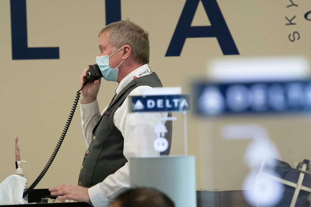 A Delta Air Lines employee calls the first passengers to board the first Delta Air Lines flight with non-stop service from Albany International Airport to New York's LaGuardia Airport at Albany International Airport on Wednesday, Jan. 5, 2022 in Colonie N.Y.