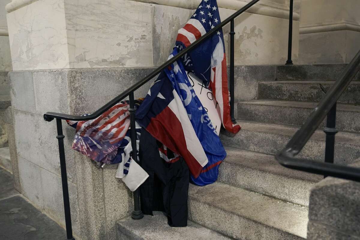 A variety of flags carried by rioters at the U.S. Capitol in Washington, that were left behind outside one of the entrances on Jan. 6, 2021. (AP Photo/J. Scott Applewhite)