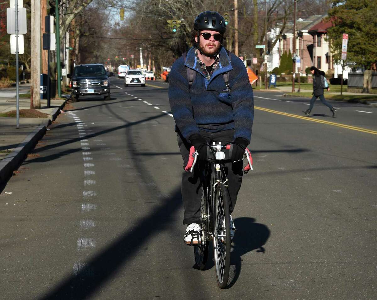 A bicyclist travels toward downtown on Whitney Avenue in New Haven Jan. 4, 2022.