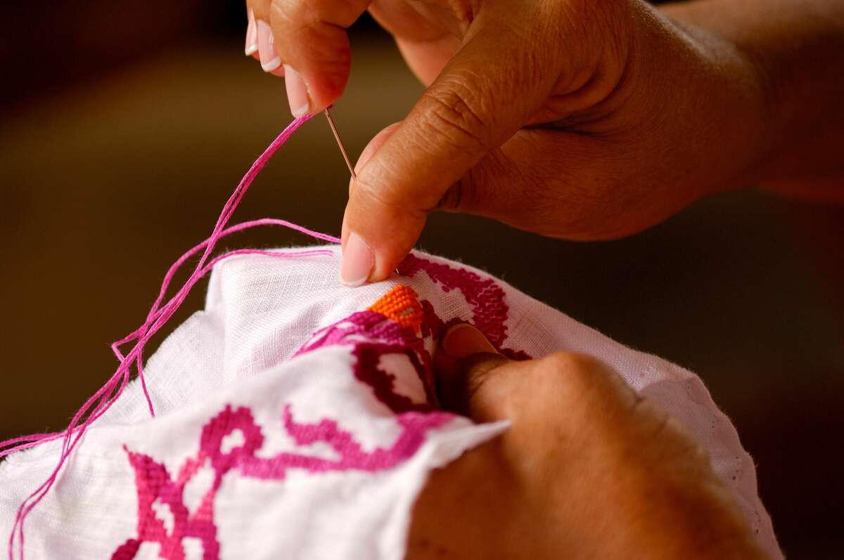 Hand-stitching pollera, Panama’s national dress.