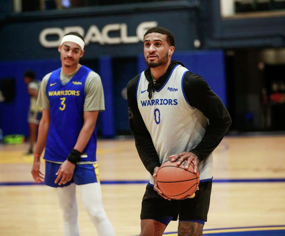 Warriors guard Gary Payton II (right) practices his shot under the watchful eye of teammate Jordan Poole.
