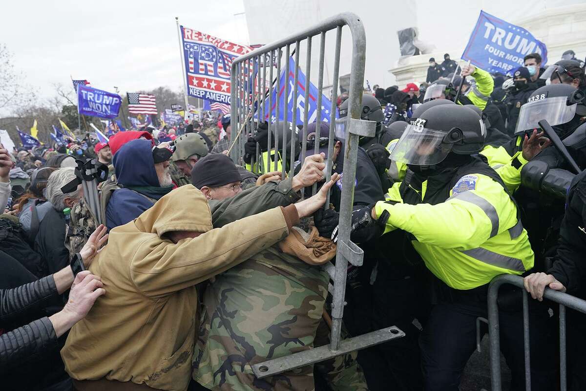 Trump supporters try to force their way through a police barricade in front of the U.S. Capitol on Jan. 6, 2021, hoping to stop Congress from finalizing Joe Biden's victory in the 2020 presidential election.