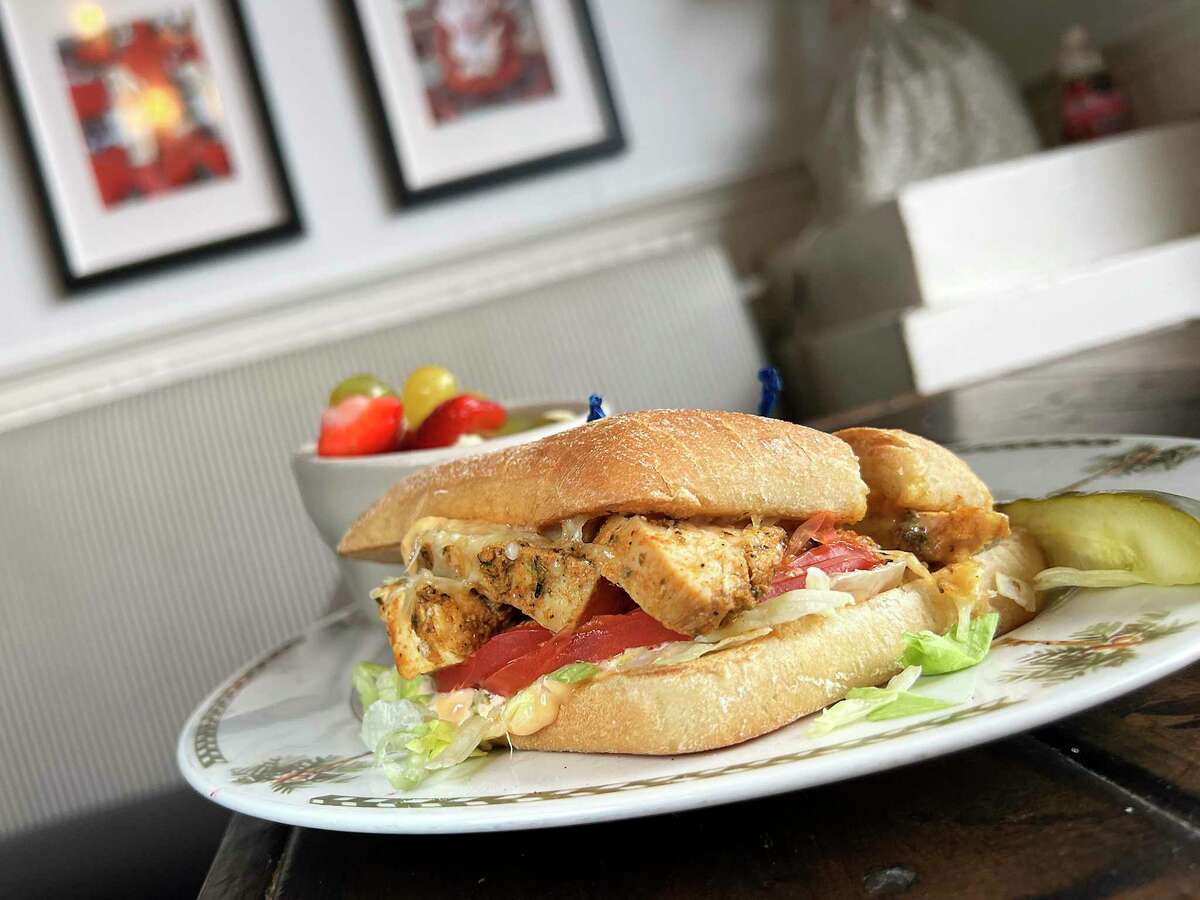 The hearty chicken chipotle Parmesan sandwich on a ciabatta roll tops roasted chicken and melted Parmesan with chipotle mayo. Fresh fruit is a refreshing side.