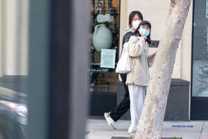 People wear face masks walking down Chestnut Street in San Francisco, Calif. on Jan. 4, 2022.