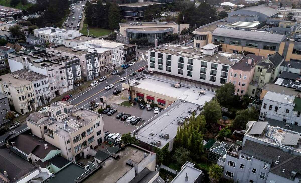 An overhead view of the proposed site of the expansion of University High School on California Street in San Francisco. The construction would replace the parking lot and a retail and medical office complex anchored by Pet Food Express (center).