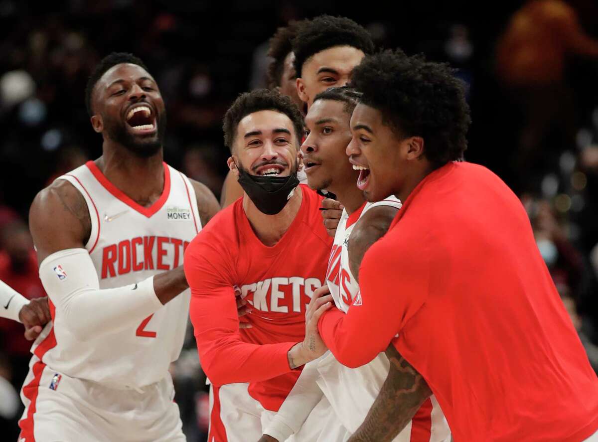 Houston Rockets' Kevin Porter Jr., second from right, celebrates with teammates after making the game-winning 3-point shot in the team's NBA basketball game against the Washington Wizards, Wednesday, Jan. 5, 2022, in Washington. (AP Photo/Luis M. Alvarez)