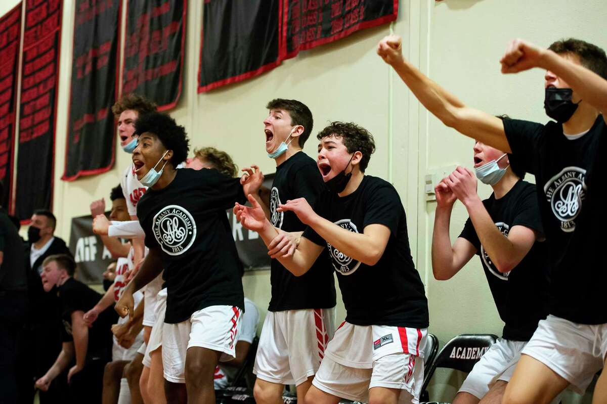 Albany Academy basketball players cheer from the bench for a basket made by a teammate on the court during a game against Mekeel Christian Academy on Wednesday, Jan. 5, 2022, in Albany, N.Y. (Jenn March, Special to the Times Union)