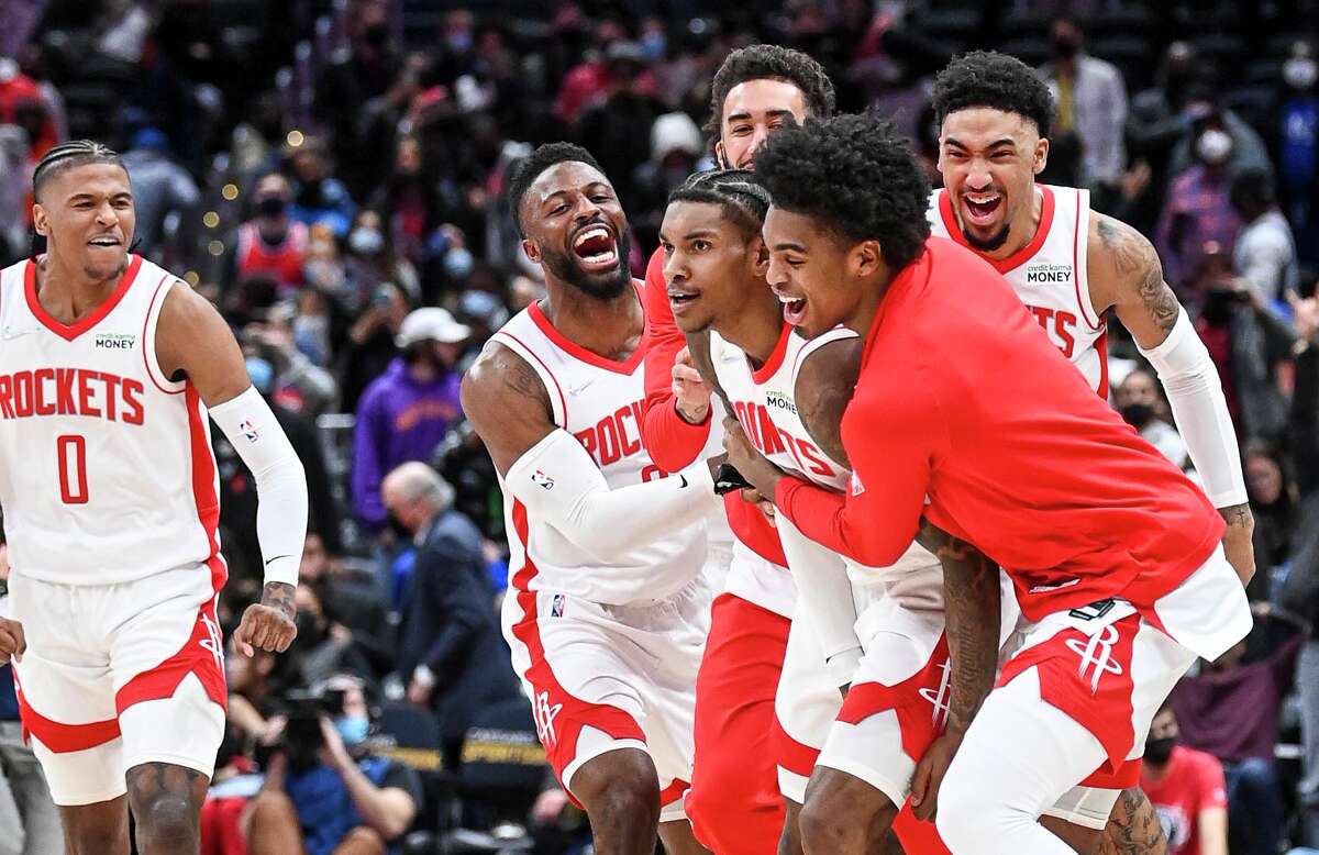 Kevin Porter Jr. gets some love from his teammates after his game-winning three-pointer lifted the Rockets past the Wizards. MUST CREDIT: Washington Post photo by Jonathan Newton