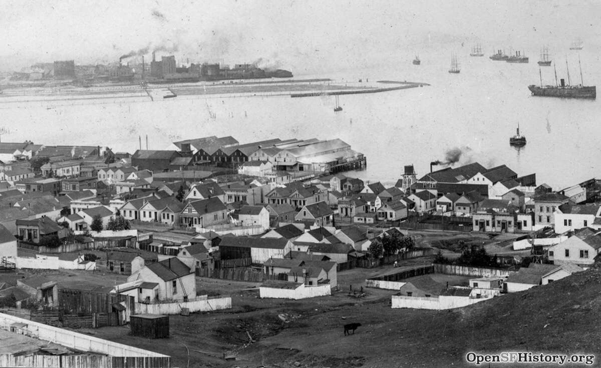 Photo postcard view of Butchertown northeast from the hill toward Islais Creek outlet. Fairfax Avenue, cottages, California Tallow Works, Chas. F. Lengeman shop in 1915. 