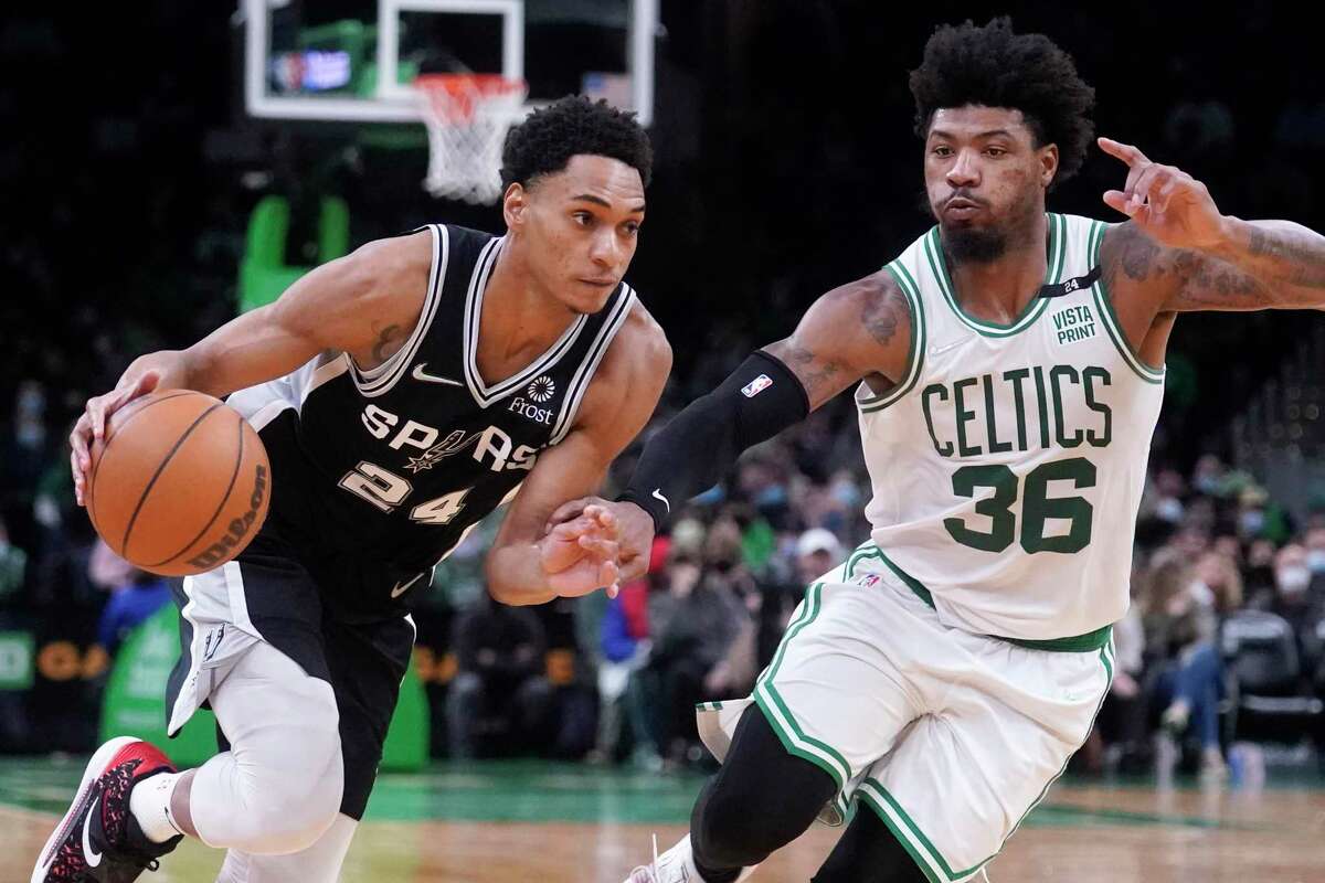San Antonio Spurs guard Devin Vassell (24) drives to the basket against Boston Celtics guard Marcus Smart (36) during the second half of an NBA basketball game, Wednesday, Jan. 5, 2022, in Boston. (AP Photo/Charles Krupa)