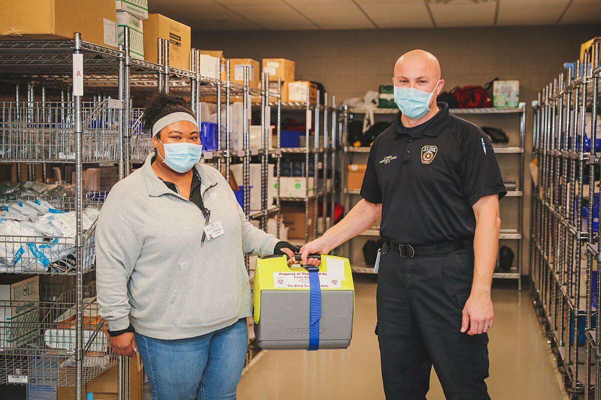 Gulf Coast Regional Blood Center employee Chynna Sands delivers the first shipment of whole blood and blood products to the Cy-Fair Fire Department on January 5, 2022 in Houston.  The Cy-Fair <a class=