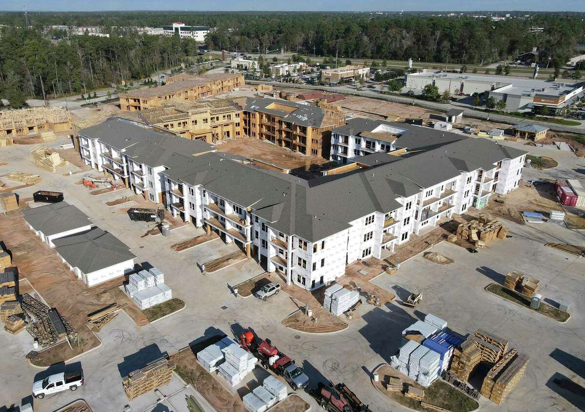 Construction on an apartment complex along Grand Village Boulevard continues in Grand Central Park, Thursday, Dec. 23, 2021, in Conroe.