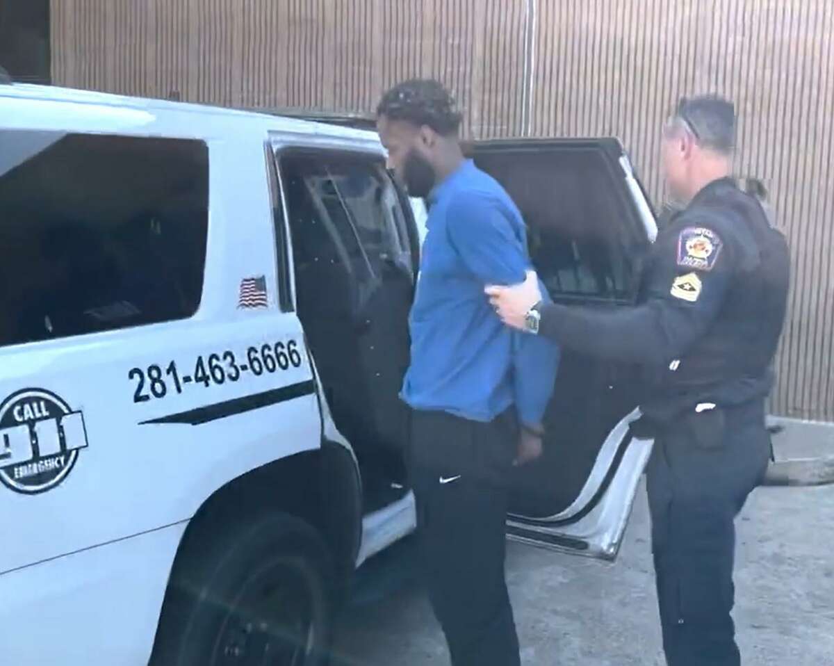 A Harris County Precinct 5 Constable deputy escorts Marlon Anthony Bryan, 28, after his arrest on Jan. 4, 2022. Bryan has been charged with trafficking of persons, promoting prostitution and tampering/fabricating evidence.
