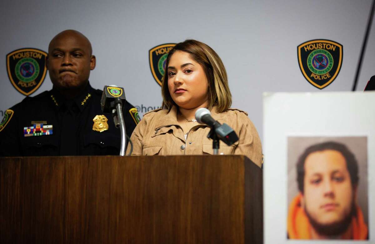 Harris County Precinct 4 deputy constable Kareem Atkins' widow, Nadia Atkins speaks next to the mug shot of Eddie Alberto Miller, right, during a press conference at the Houston Police Department headquarters, Monday, Dec. 13, 2021, in Houston. Miller has been accused of killing deputy constable Atkins.
