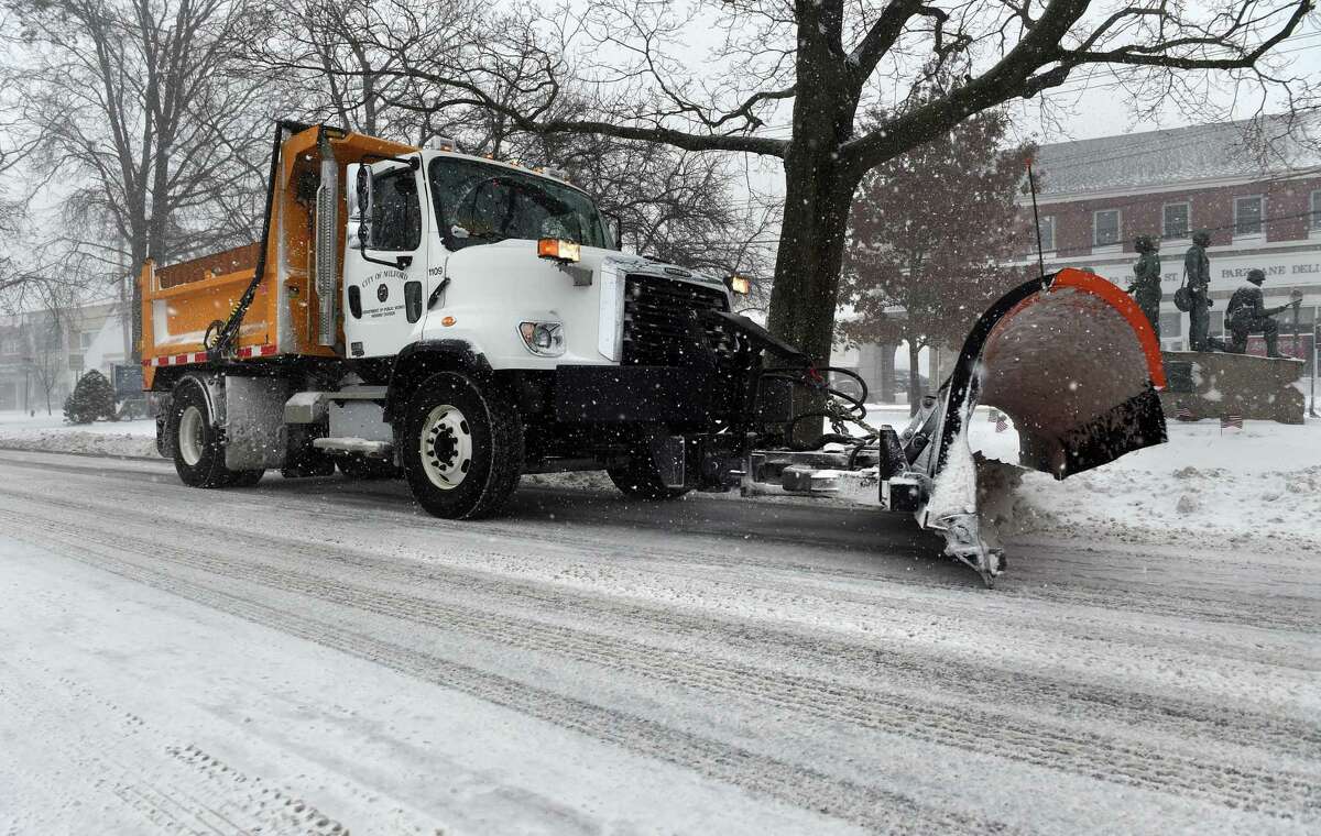 A Milford Public Works vehicle clears snow on Broad Street in Milford on February 1, 2021.