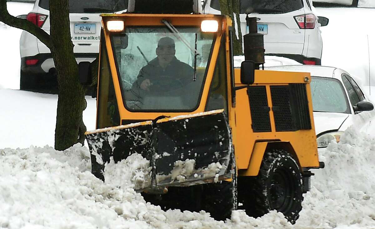 City of Norwalk DPW workers clear the parking lots at City Hall Tuesday, Fevruary 2, 2021, in Norwalk, Conn.