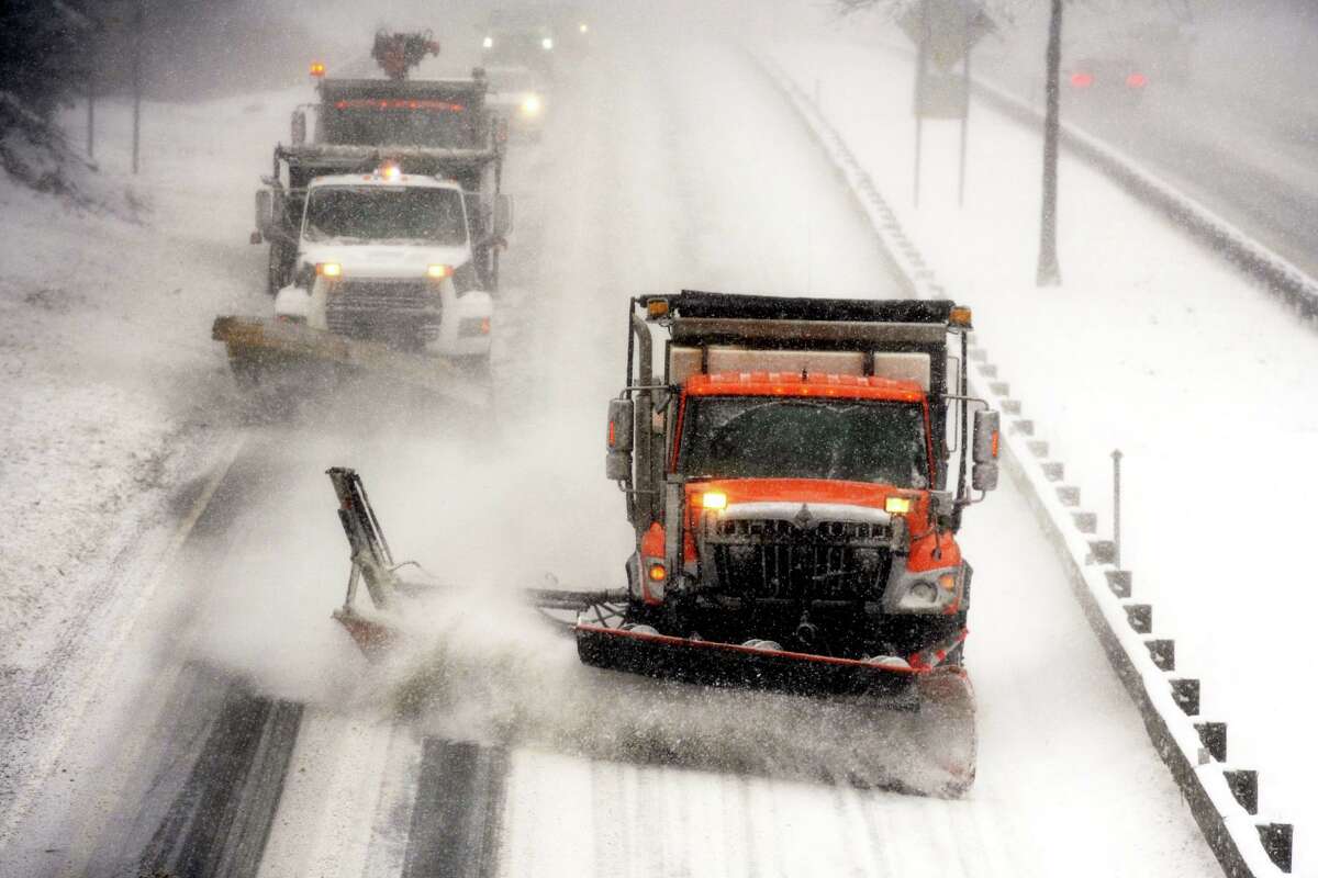 State trucks plows snow along the Merritt Parkway, in Stratford, Conn. Feb. 1, 2021.