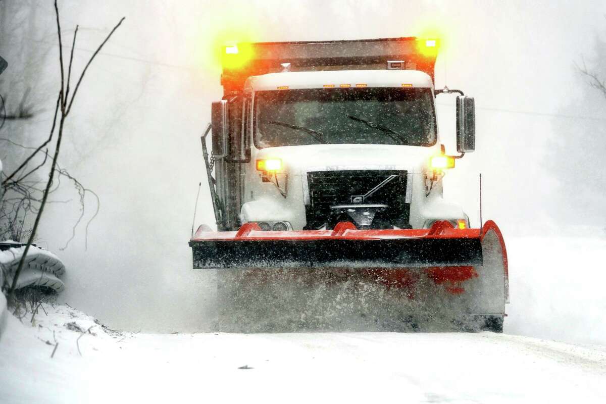 A department of public works truck plows snow along James Farm Rd., in Stratford, Conn. Feb. 1, 2021.