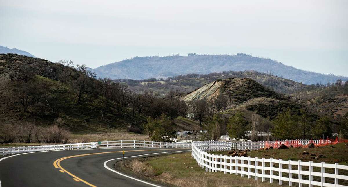 White fencing is seen along Butts Canyon Road where a luxury housing development is being considered in Lake County. The 1,400-home project was put on hold by a superior court judge this week because of wildfire concerns.