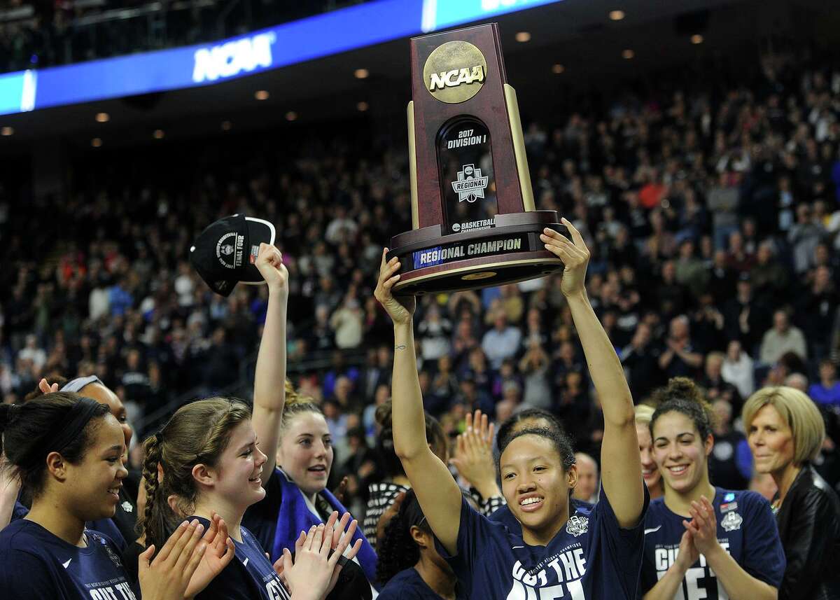 Surrounded by her teammates, UConn senior Saniya Chong lifts the Regional Championship Trophy following their victory over Oregon in the 2017 NCAA Women’s Basketball Regional Final game at the Webster Bank Arena in Bridgeport.