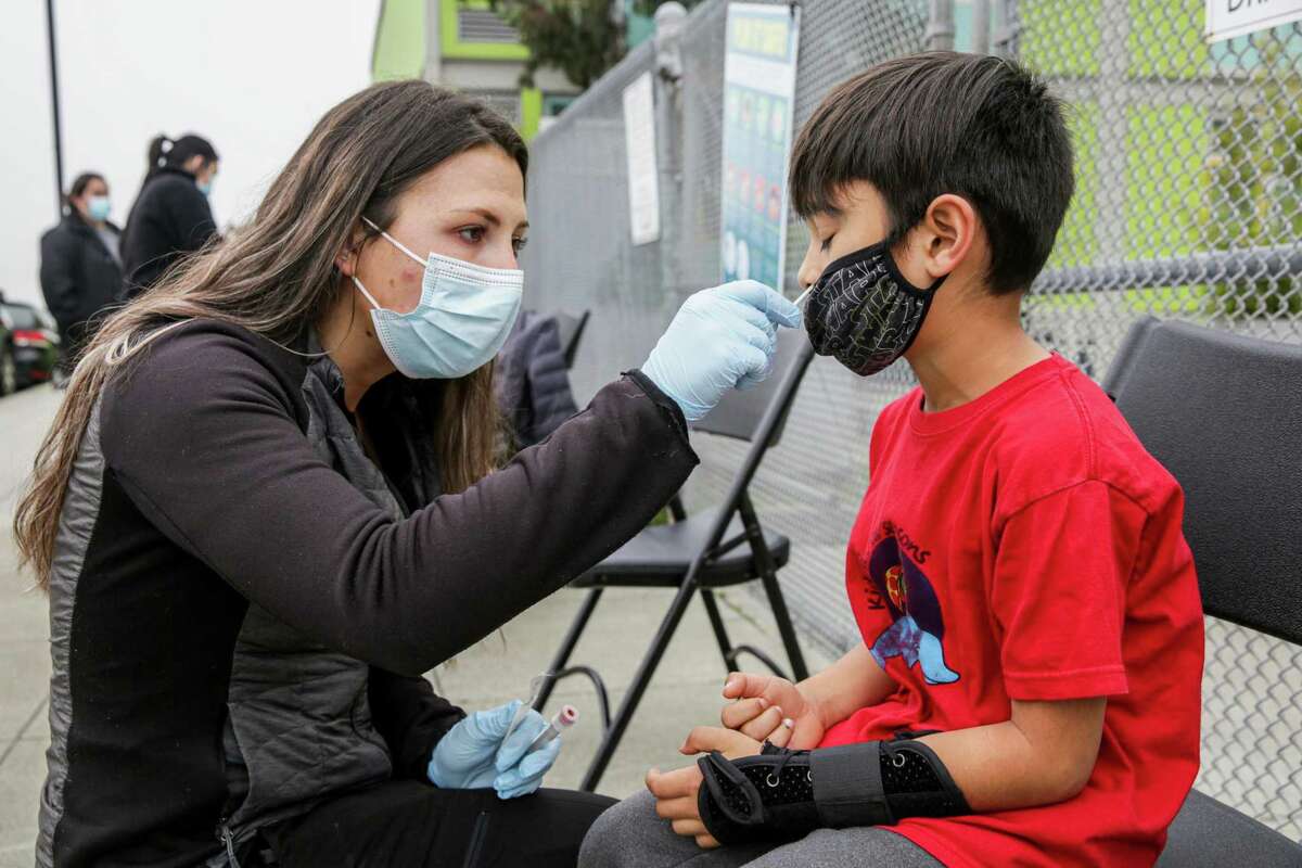 Daniel Webster Elementary student Anil Billon, 6, receives a COVID-19 test outside of his school in San Francisco.