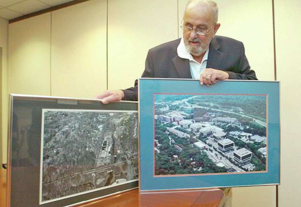 Bert D Phelps of A D Phelps, who recently sold his Merritt 7 Office Park, looks over photos of the area before and after the park was built. Hour photo / Erik Trautmann