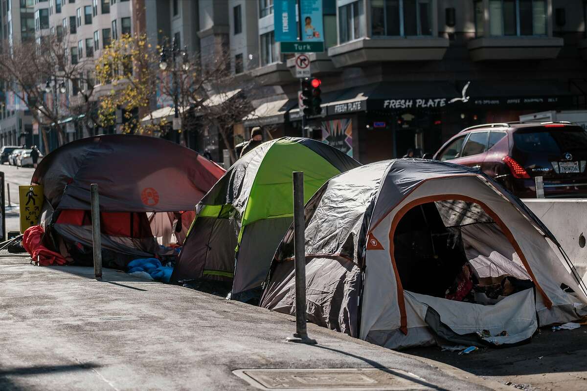 A row of tents is seen on the corner of Jones and Turk streets. Five blocks up the hill, a new homeless shelter is proposed.
