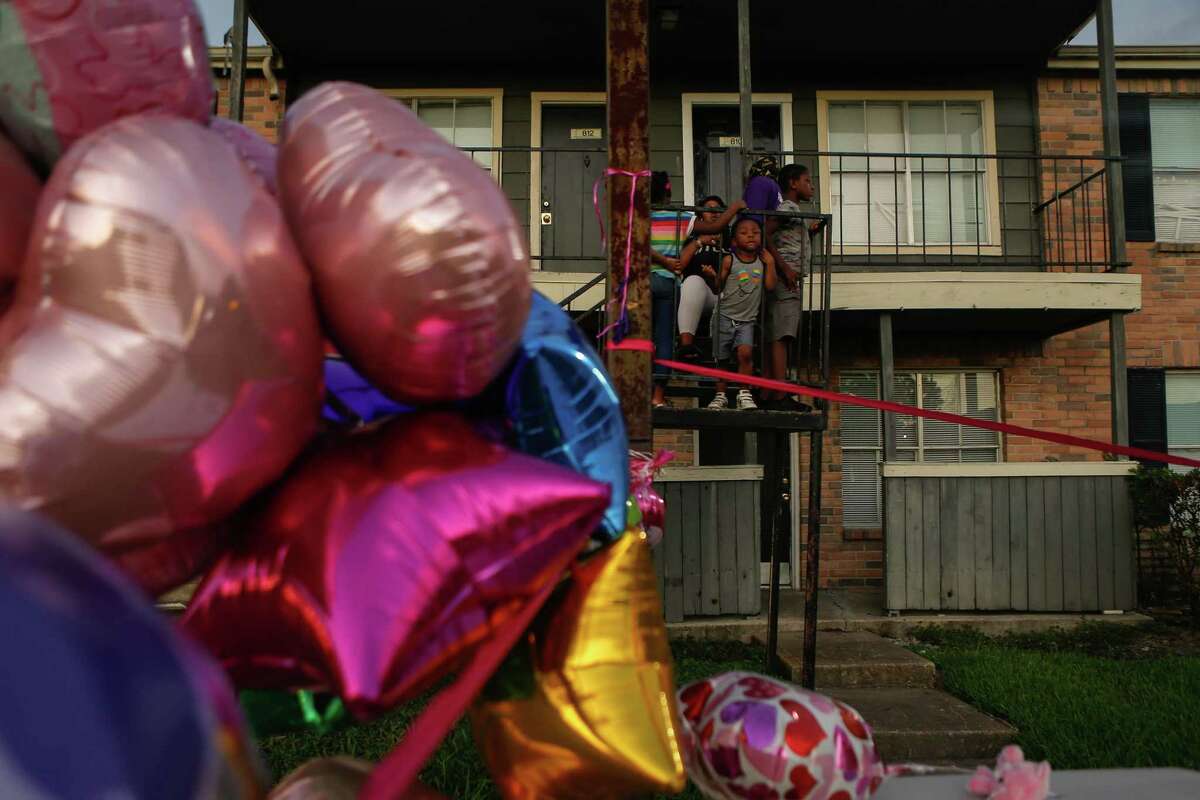 Maliyah Bass’ neighbors looked onto the mourning friends and family at a vigil at the Sunset Crossing apartment complex in Alief on Saturday, August 29, 2020, where Maliyah was last seen.