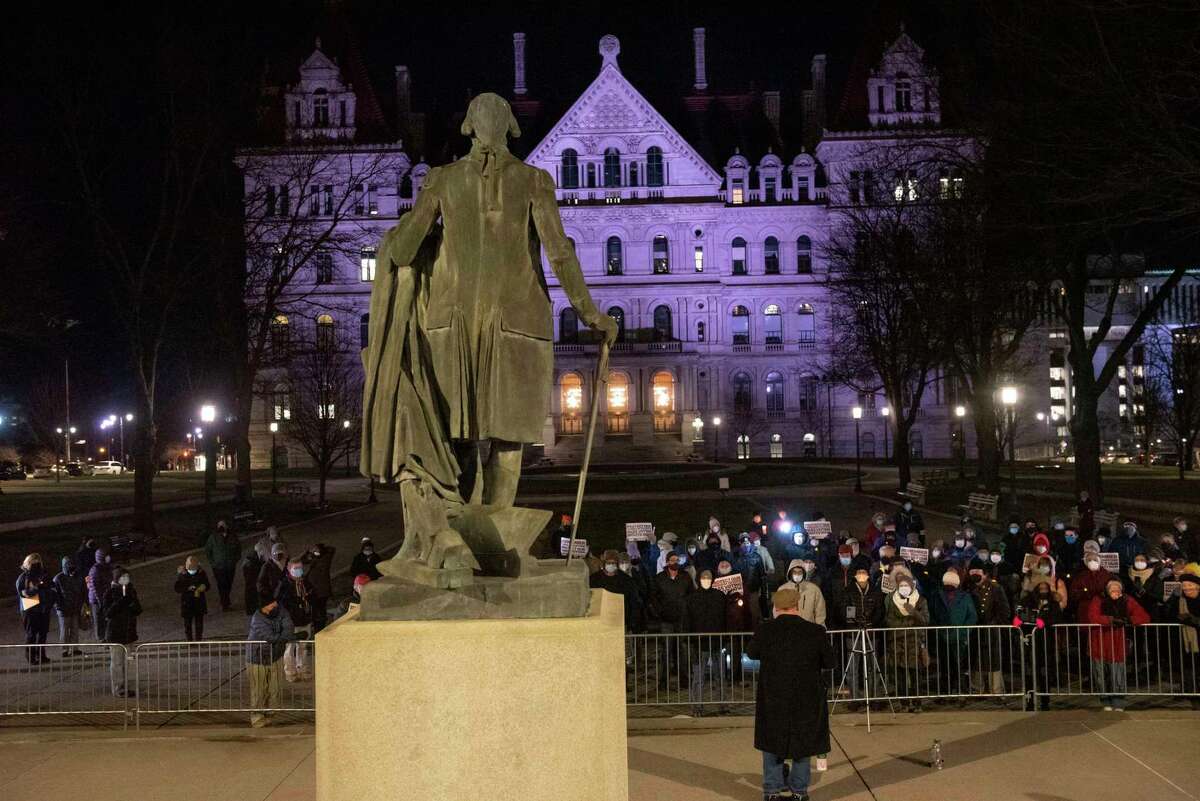 Local progressive groups hold a candlelight vigil "to remember the armed right wing attack on our American Democracy!" at West Capitol Park on Thursday, Jan. 6, 2022 in Albany, N.Y.