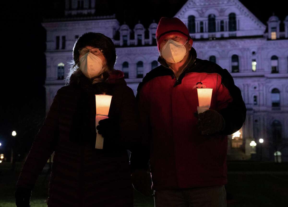 Local progressive groups hold a candlelight vigil "to remember the armed right wing attack on our American Democracy!" at West Capitol Park on Thursday, Jan. 6, 2022 in Albany, N.Y.