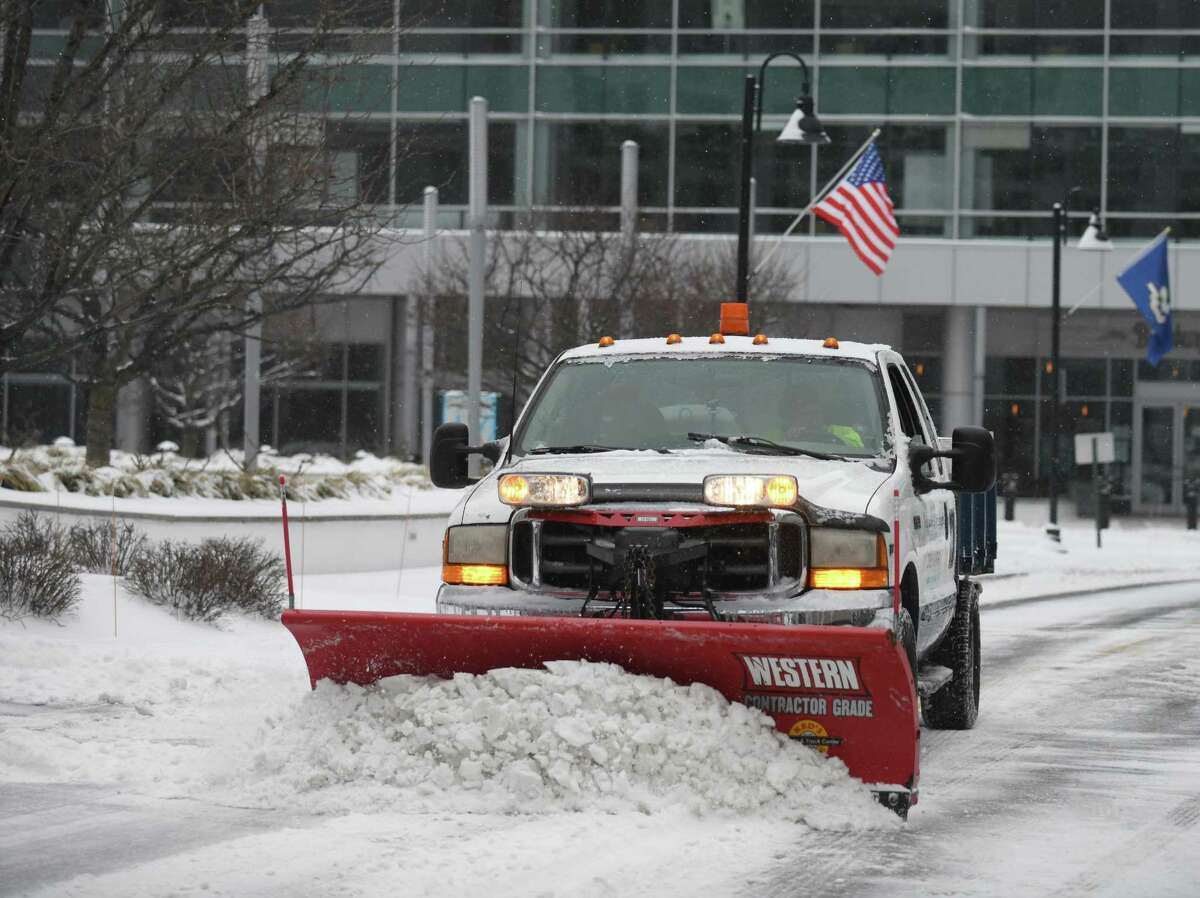 A plow clears snow at Harbor Point in Stamford on Feb. 18, 2021.