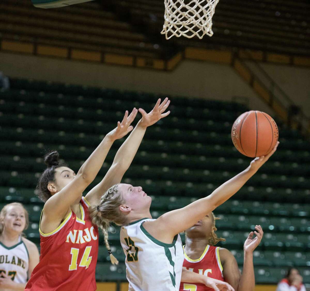 Midland College's Bella Green lays up a shot after driving baseline under the basket around New Mexico Junior College's Bianca Juzzo 01/06/2022 at the Chaparral Center. Tim Fischer/Reporter-Telegram
