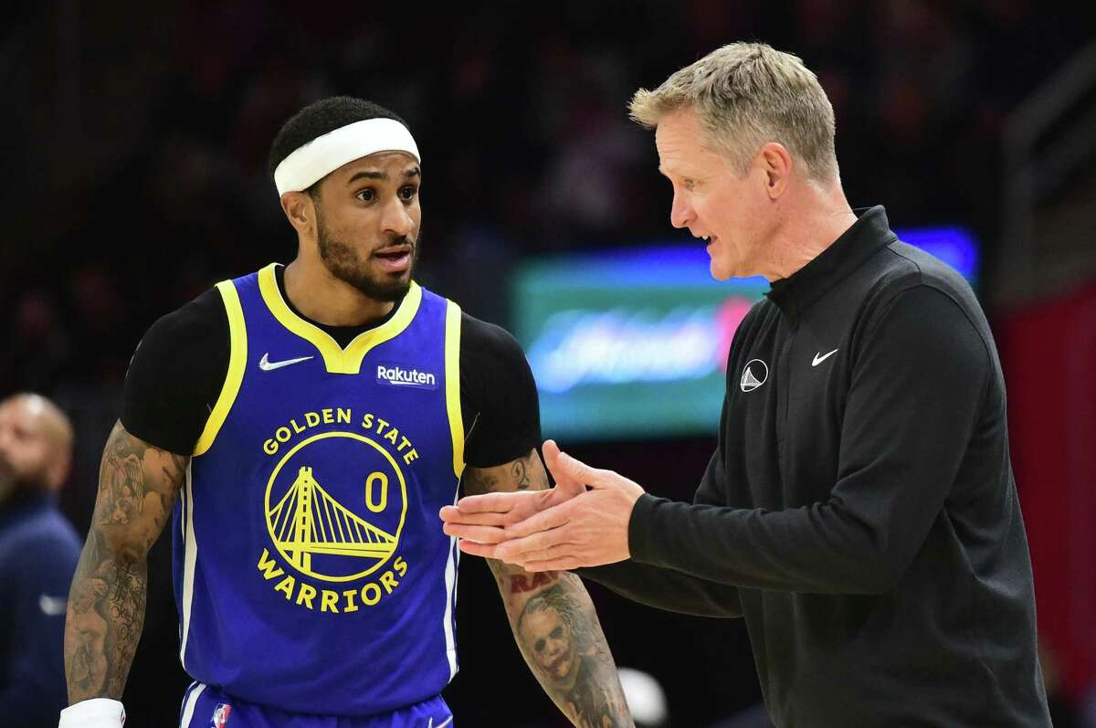 CLEVELAND, OHIO - NOVEMBER 18: Gary Payton II #0 talks to head coach Steve Kerr of the Golden State Warriors during the third quarter against the Cleveland Cavaliers at Rocket Mortgage Fieldhouse on November 18, 2021 in Cleveland, Ohio. The Warriors defeated the Cavaliers 104-89. NOTE TO USER: User expressly acknowledges and agrees that, by downloading and/or using this photograph, user is consenting to the terms and conditions of the Getty Images License Agreement. (Photo by Jason Miller/Getty Images)