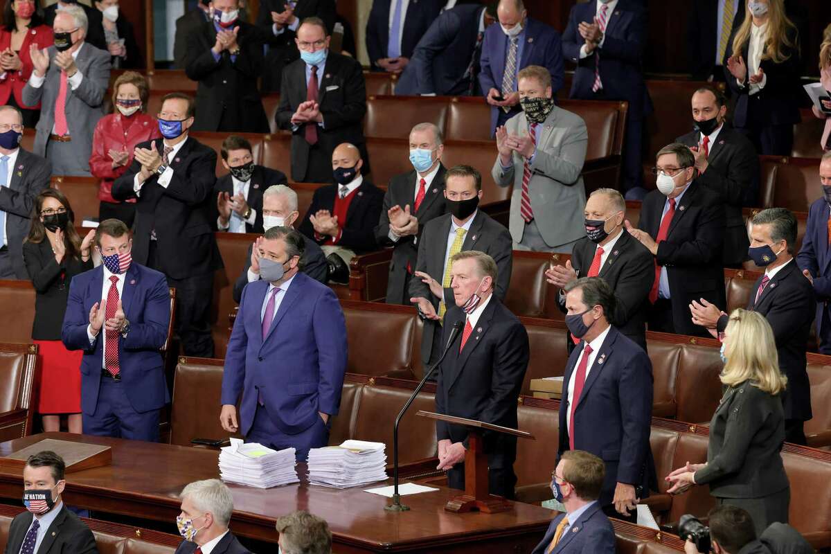 Rep. Paul Gosar, R-Ariz., third from right, and Sen. Ted Cruz, R-Texas, second from left, are applauded by Republican members of Congress after they objected to the certification of the electoral votes for the state of Arizona during a Joint Session of Congress on Jan. 6, 2021, in Washington, D.C. (Win McNamee/Getty Images/TNS)