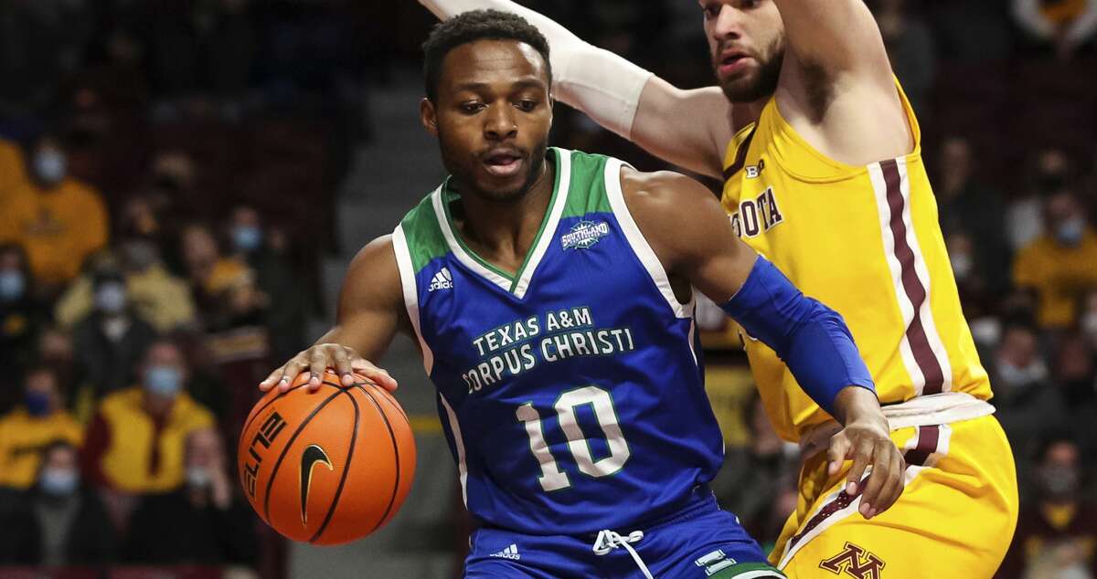Texas A&M Corpus Christi forward Isaac Mushila (10) drives against Minnesota forward Jamison Battle (10) during the first half of an NCAA college basketball game Tuesday, Dec. 14, 2021, in Minneapolis. (AP Photo/David Berding)