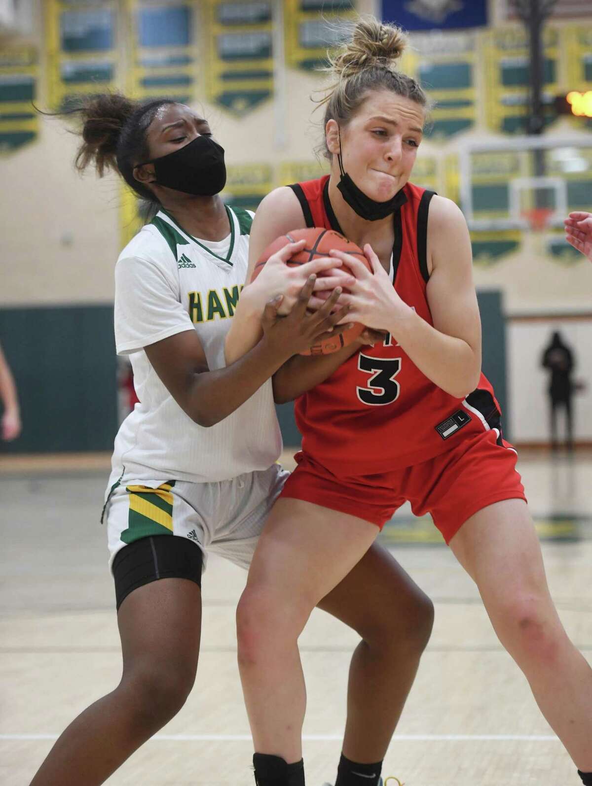 Hamden’s Thailyn Geter, left, fights for a rebound with Sacred Heart Academy’s Carina Ciampi on Thursday.