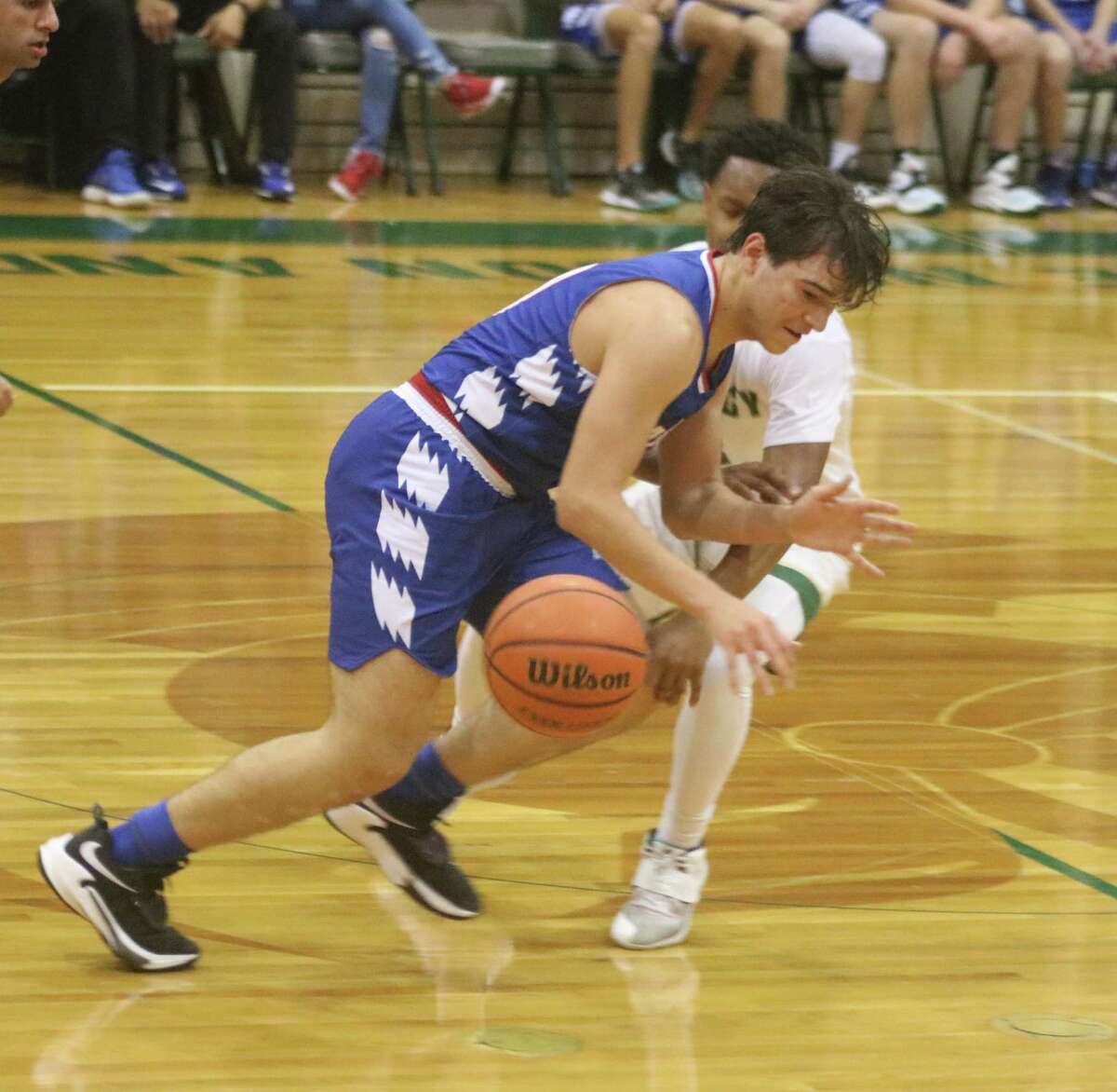 Pasadena-First Baptist player Matthew Ybarra tries to hurry the ball down the floor while a Legacy player looks for the steal In Beaumont Tuesday night.