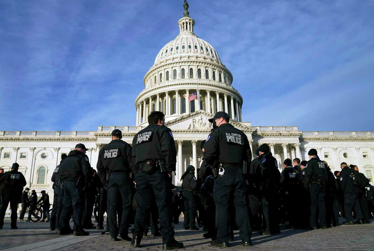 A large group of police arrive at the Capitol, Thursday, Jan. 6, 2022, in Washington. President Joe Biden and members of Congress are solemnly marking the first anniversary of the Jan. 6 U.S. Capitol insurrection. Lawmakers are holding events Thursday to reflect on the violent attack by supporters of then-President Donald Trump. The ceremonies will be widely attended by Democrats, but almost every Republican on Capitol Hill will be absent.