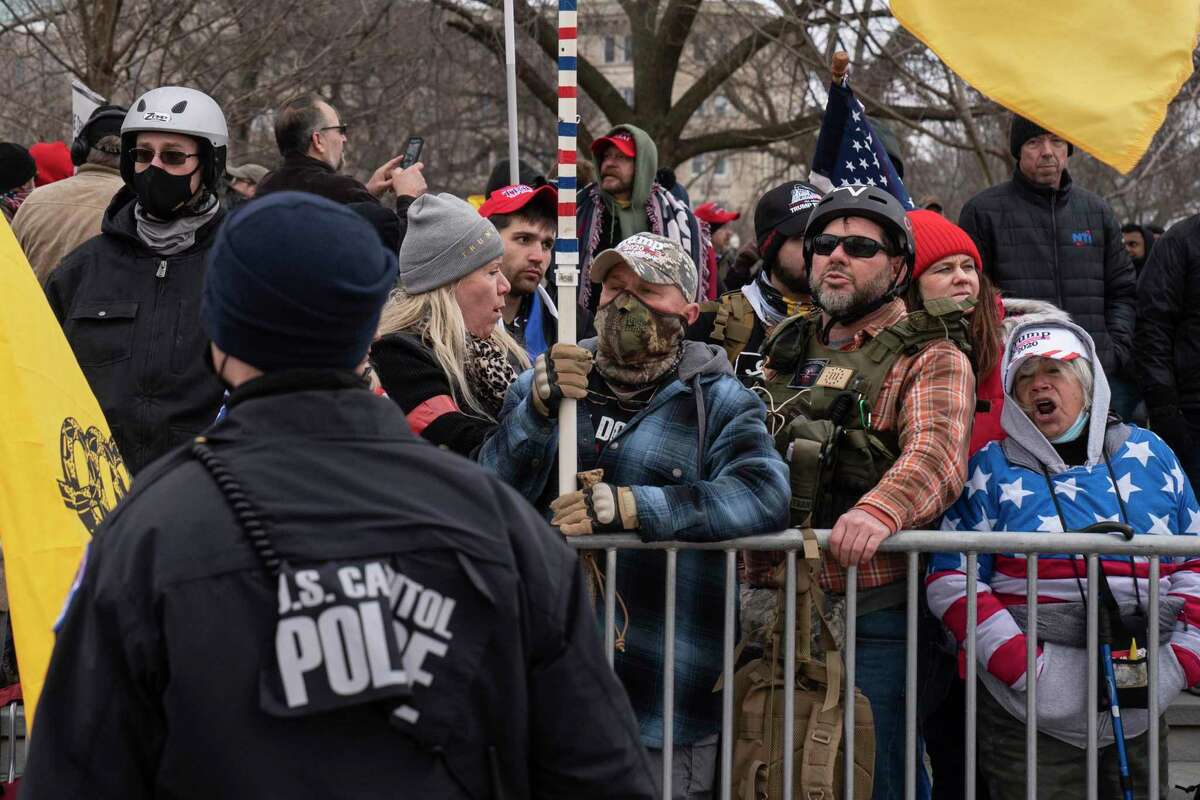 Donald Trump supporters stand on the east side of the U.S. Capitol on Jan. 6, 2021, before they stormed and breached the building to support Trump's false claims that he won the election.
