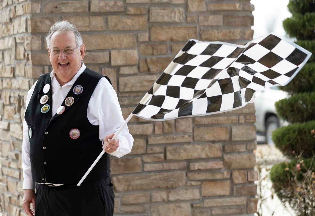 Montgomery County Historical Commission chair, Larry Foerster, waves a flag once teams take off during the 8th Annual History Road Rally starting at the North Montgomery County Community Center, Saturday, Feb. 27, 2021, in Willis.