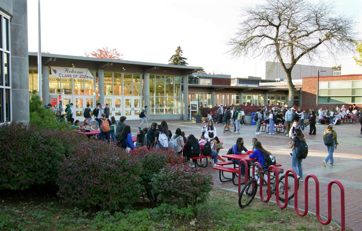 Student hang out in the courtyard after dismissal at Greenwich High School in Greenwich, Conn., on Tuesday November 9, 2021. GHS currently has the most active cases of COVID, and officials are making certain there is enough space for students to spread out at lunch time.