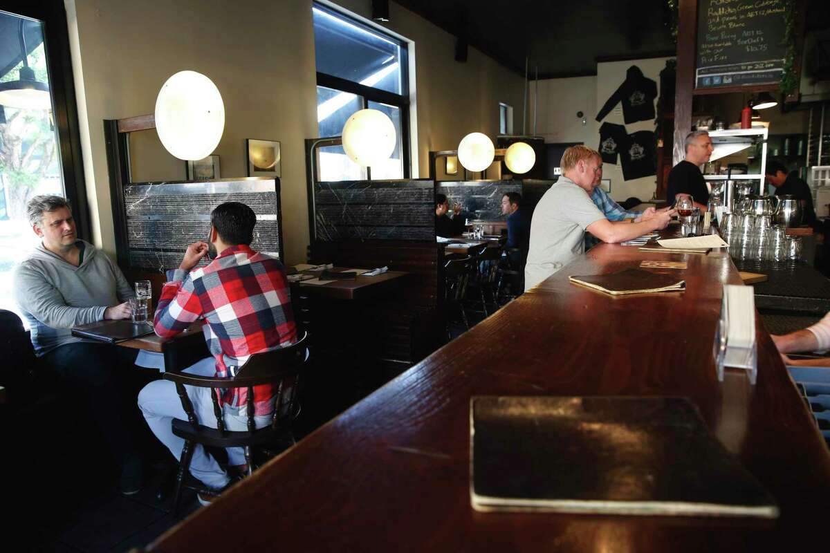 Customers eat lunch at Monk’s Kettle in San Francisco in 2017. The Mission District brewpub has temporarily closed indoor dining due to the omicron variant.