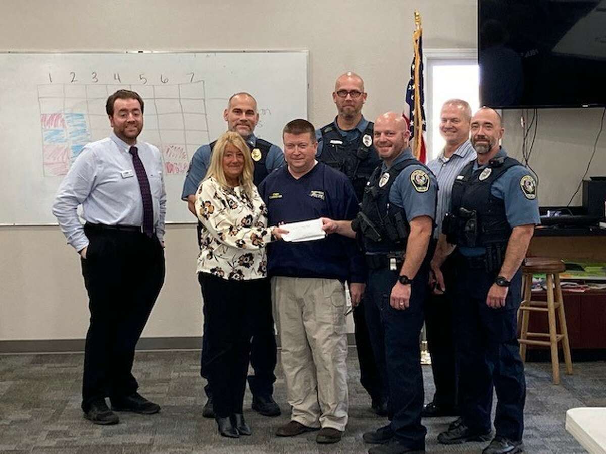 Members of the Maryville Police Department present the check to Kiwanis Club President Rob Carpenter.