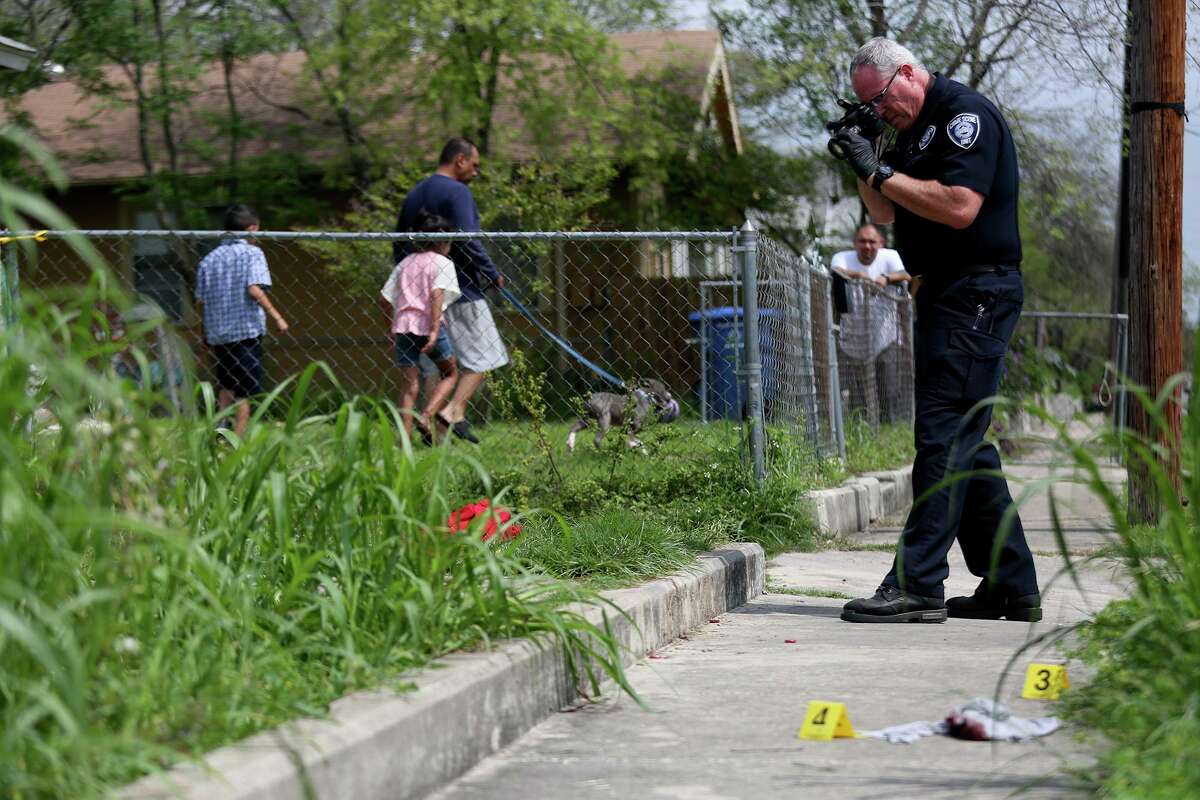A San Antonio Police Department crime scene investigator photographs evidence at the scene of a domestic violence shooting on March 18, 2016. Calls to 911 for family violence in San Antonio increased more than 14 percent during the COVID-19 lockdown period, according to a new study published in the Journal of Research in Crime and Delinquency.