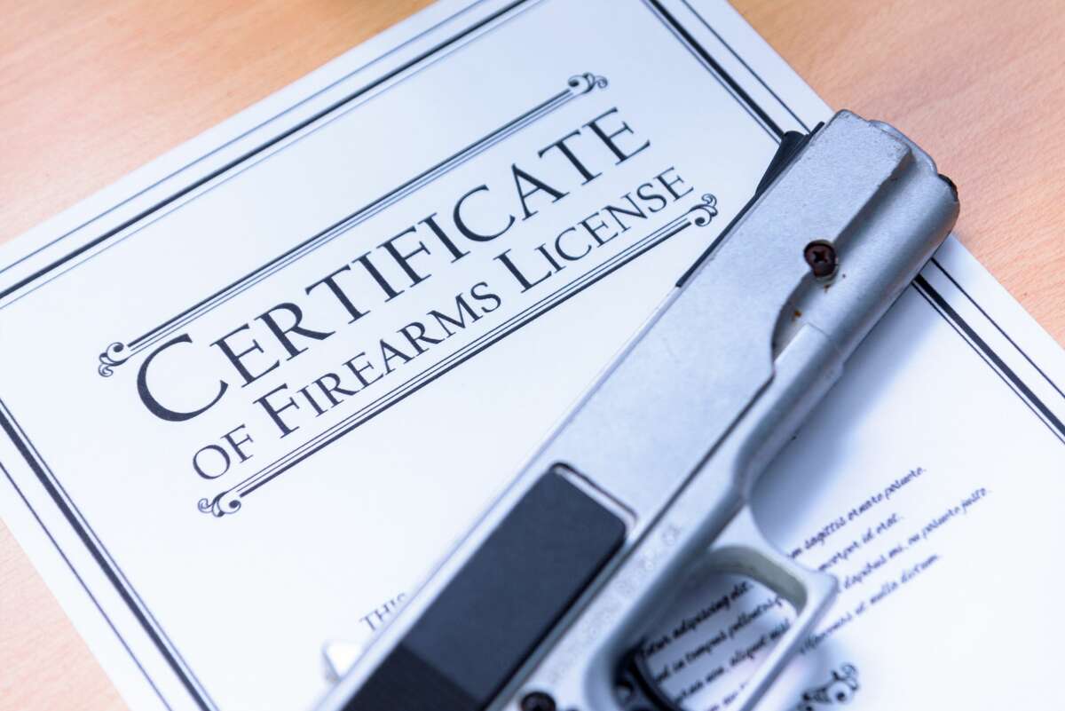 Handgun laying on a Gun / Firearms License Certificate