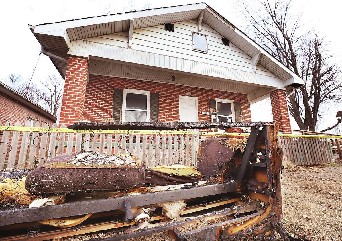 John Badman|The Telegraph A burnt couch sets by the curb outside a house in the 400 block of Evans Street in Wood River on Friday. One person died in a fire at the home at about 3:45 a.m. Friday.