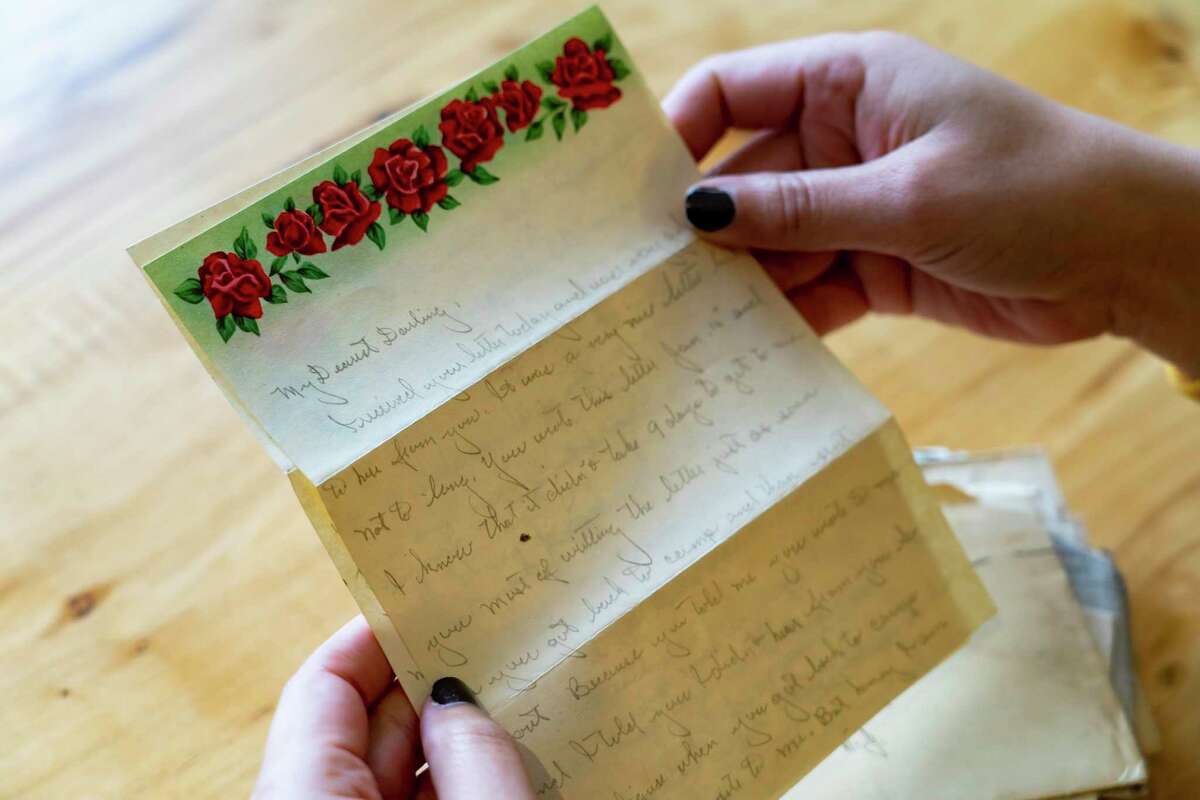 Brittany Britto looks through letters that were sent between her grandparents in the early 1950s, Friday, Jan. 7, 2022, in Houston.