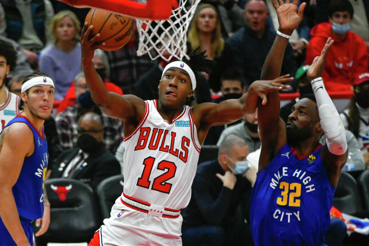 Chicago Bulls guard Ayo Dosunmu (12) scores past Denver Nuggets forward Jeff Green (32) during the second half of an NBA basketball game, Monday, Dec. 6, 2021, in Chicago.